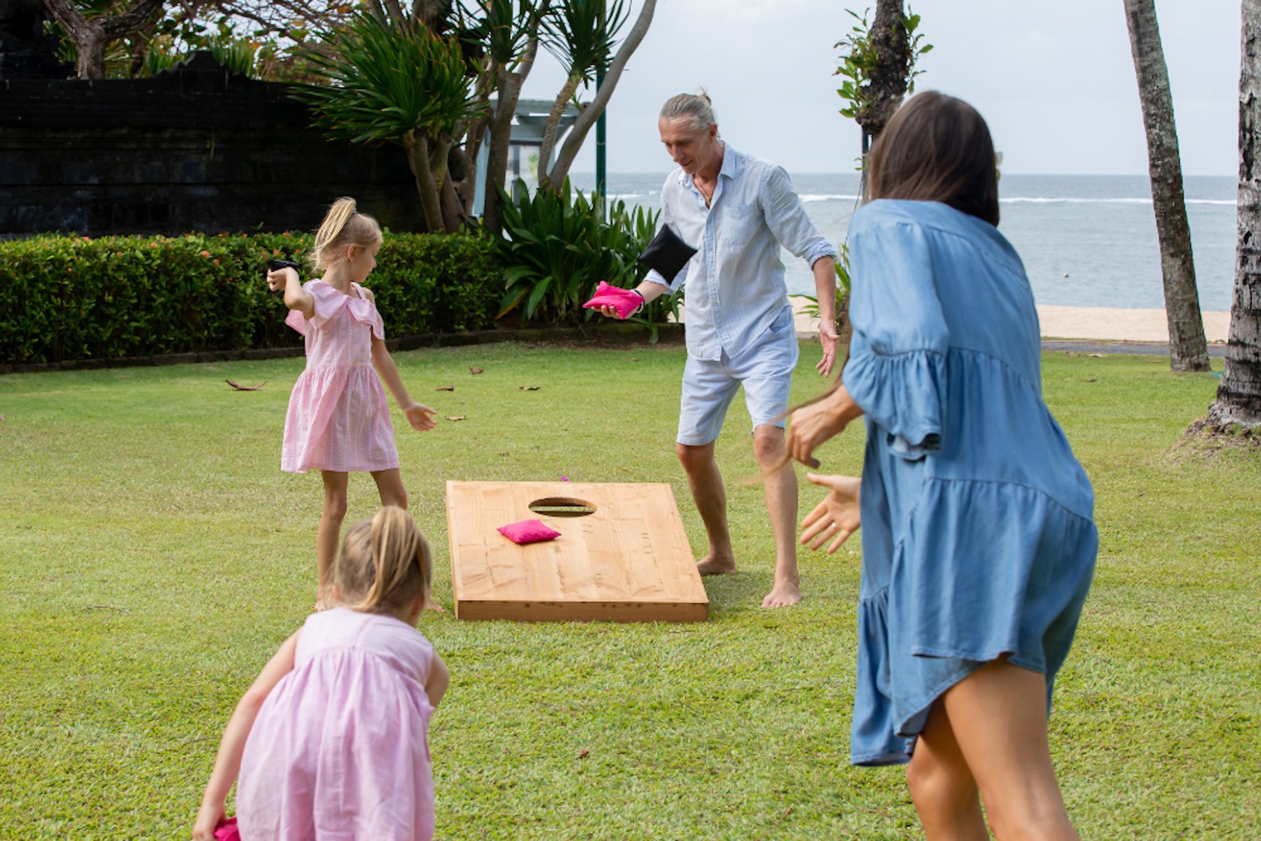 Family enjoying a game of cornhole together